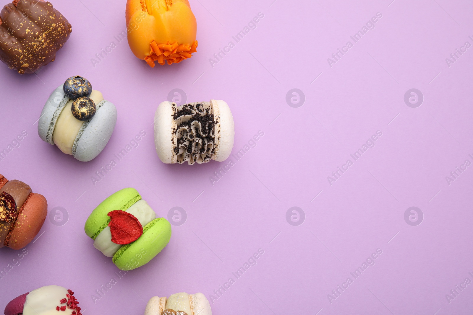 Photo of Delicious macarons on violet table, flat lay. Space for text