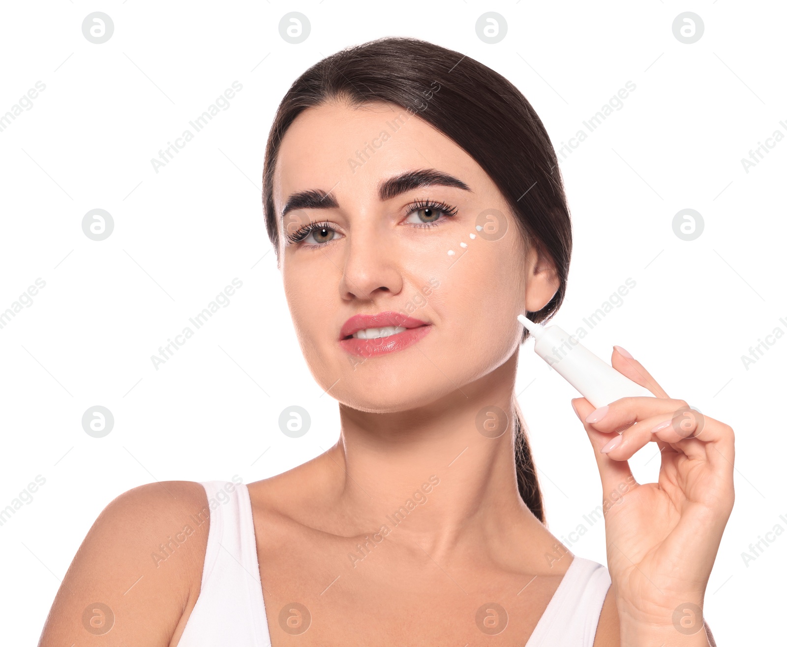 Photo of Woman with cosmetic product around eye on white background. Skin care