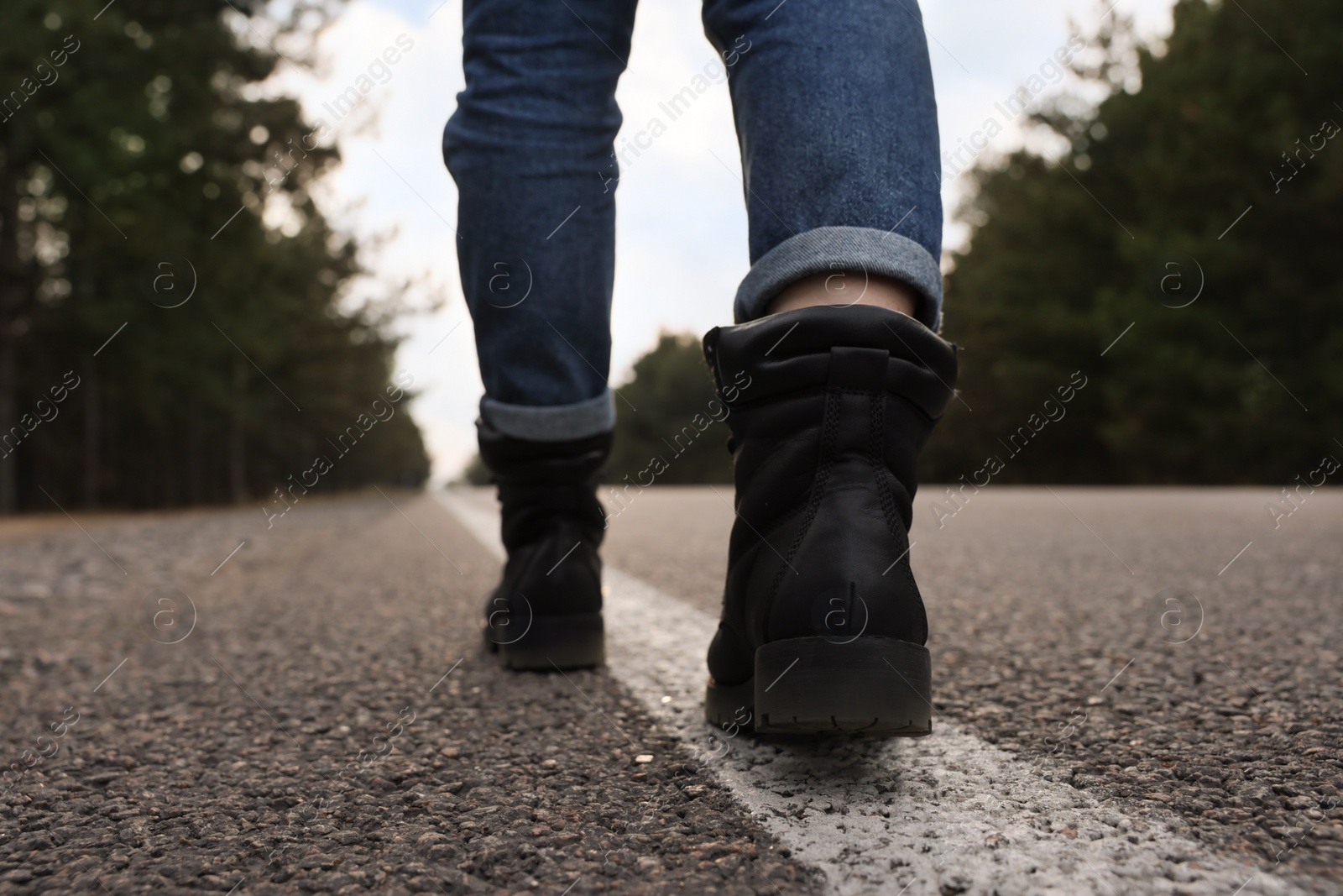 Photo of Woman going along road, closeup of legs