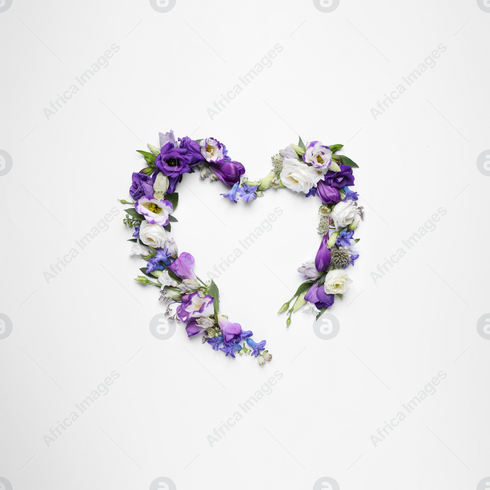 Photo of Beautiful heart made of different flowers on white background, top view