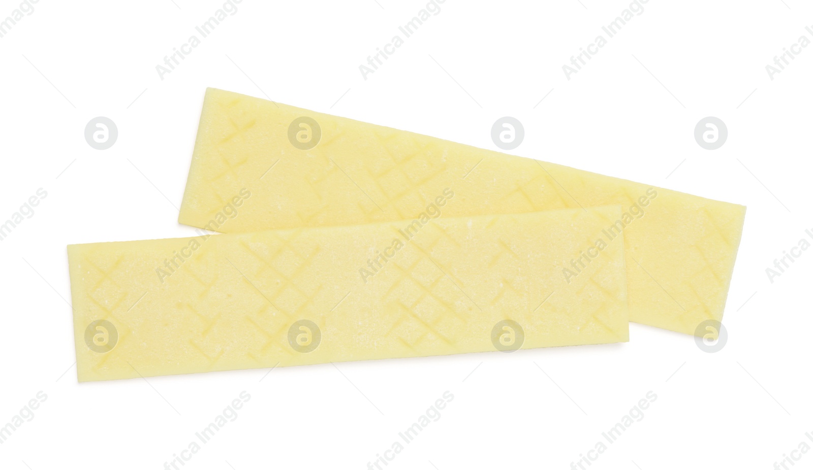 Photo of Sticks of tasty yellow bubble gums isolated on white, top view