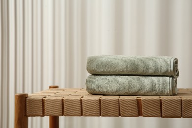 Photo of Soft towels on bench indoors, space for text