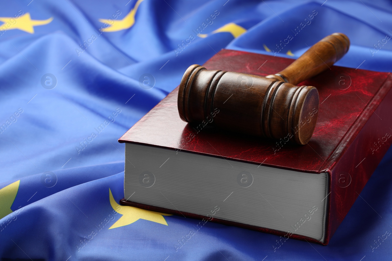 Photo of Wooden judge's gavel and book on flag of European Union, space for text