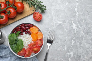 Photo of Tasty rice with beans served on light grey marble table, flat lay. Space for text