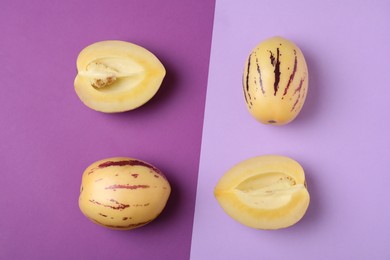 Whole and cut pepino melons on color background, flat lay