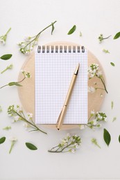 Guest list. Notebook, pen and beautiful spring tree blossoms on white background, flat lay