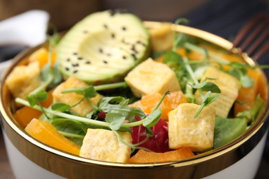 Photo of Delicious salad with tofu and vegetables in bowl, closeup