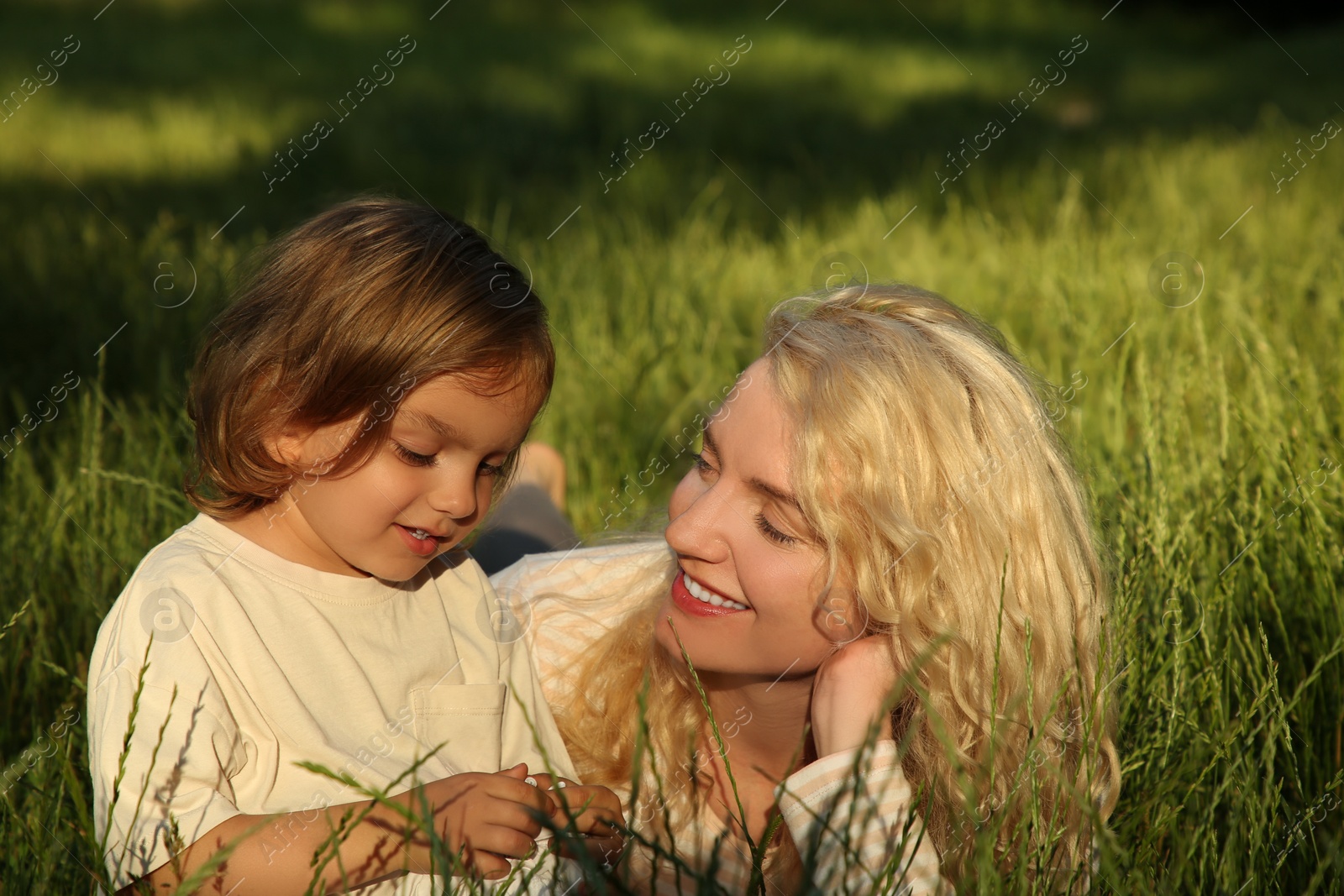 Photo of Happy mother with her cute daughter spending time together outdoors