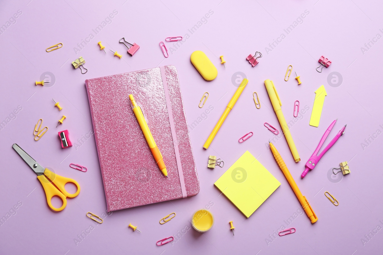 Photo of Bright school stationery on lilac background, flat lay