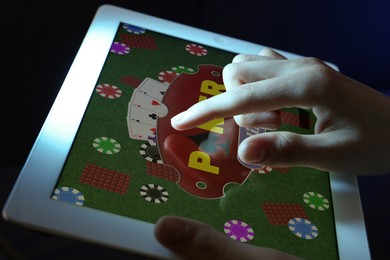 Woman playing poker on tablet, closeup. Casino online