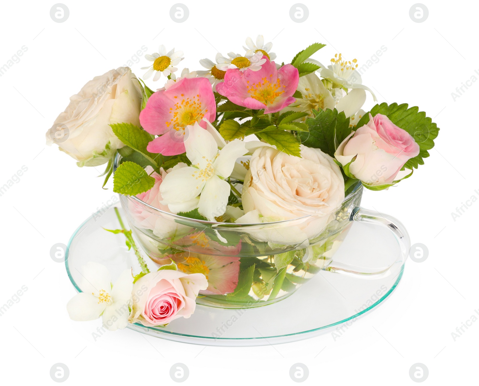 Photo of Aromatic herbal tea in glass cup with different flowers isolated on white