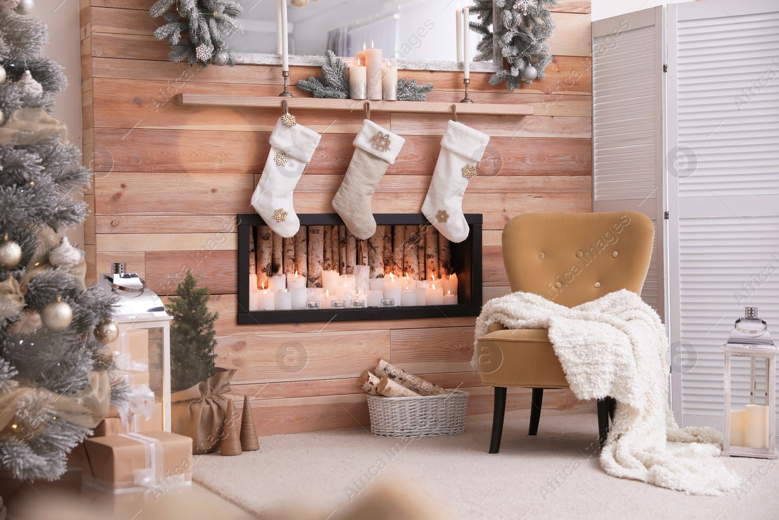 Photo of Fireplace with Christmas stockings in room. Festive interior