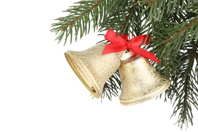 Photo of Christmas bells with red bow hanging on fir tree branch against white background