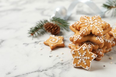 Tasty Christmas cookies on white marble table. Space for text