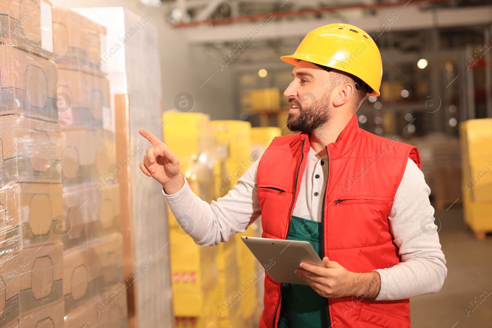 Image of Man with tablet working at warehouse. Logistics center