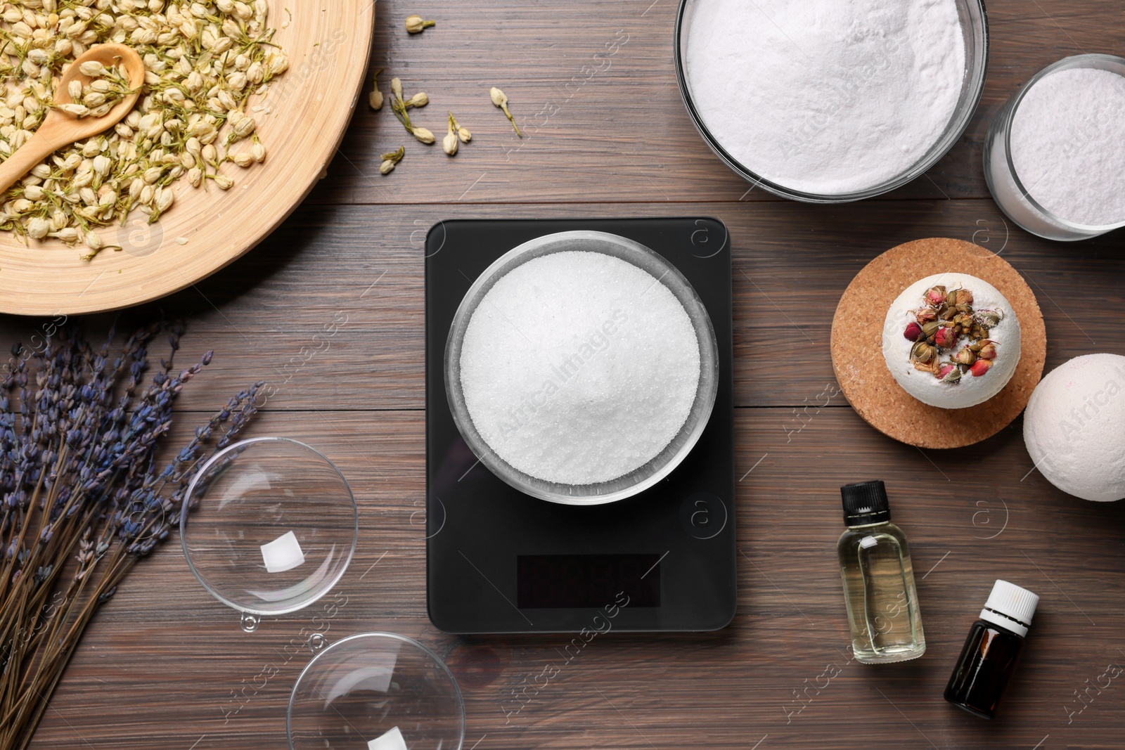 Photo of Handmade bath bombs and ingredients on wooden table, flat lay