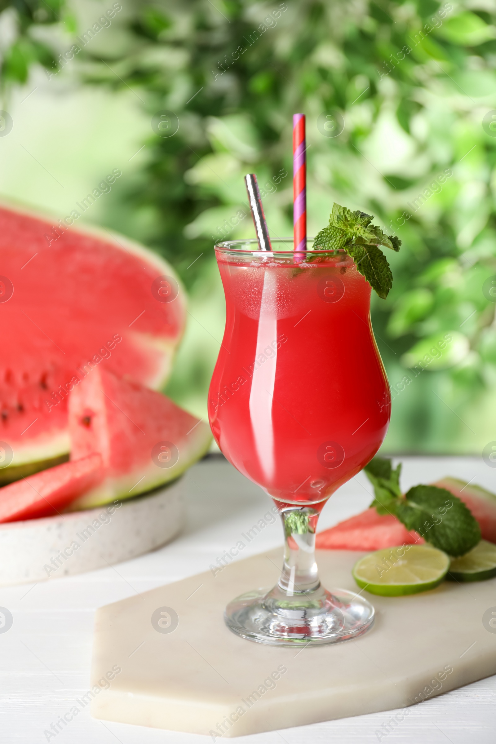 Photo of Delicious fresh watermelon drink on white wooden table