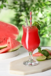 Delicious fresh watermelon drink on white wooden table