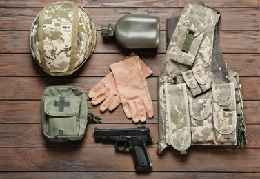 Photo of Set of military outfit on wooden background, flat lay