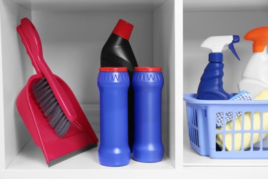 Photo of Different cleaning supplies and tools on shelves