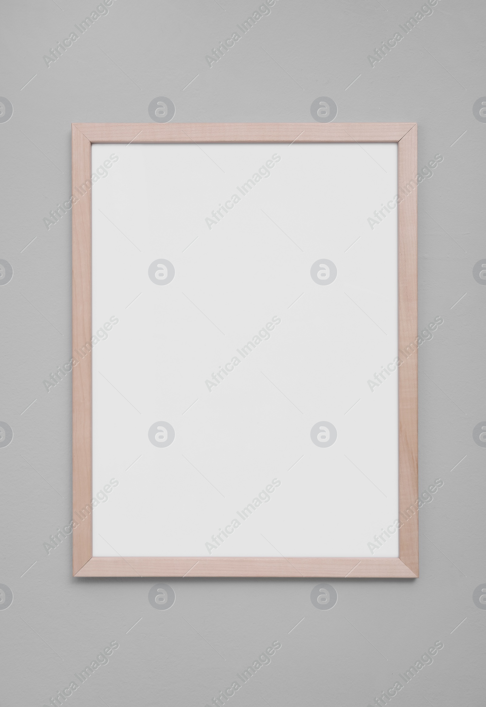 Photo of Empty frame on grey wall. Mockup for design