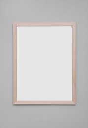 Photo of Empty frame on grey wall. Mockup for design