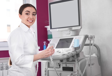 Photo of Sonographer using modern ultrasound machine in clinic