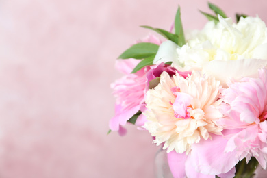 Photo of Bouquet of beautiful peonies on pink background, closeup. Space for text