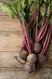 Raw ripe beets on wooden table, flat lay