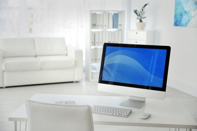 Comfortable workplace with computer on desk in home office