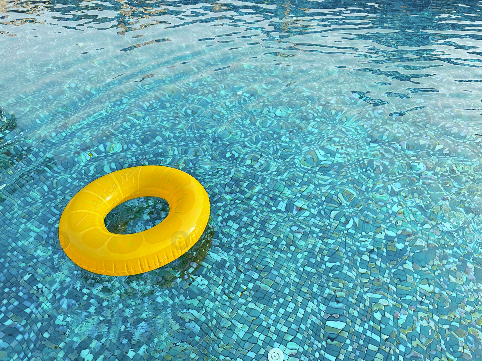 Photo of Yellow inflatable ring in swimming pool outdoors