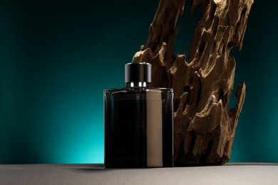 Luxury men`s perfume in bottle on grey table against color background