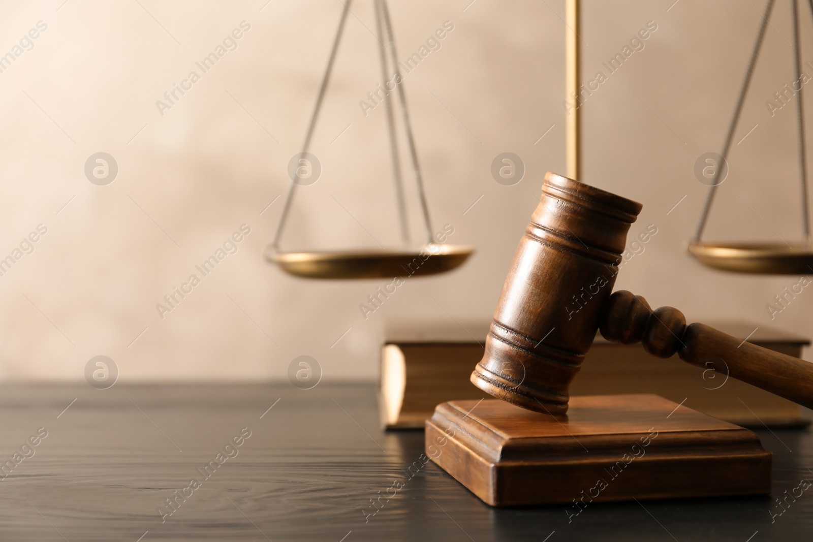 Photo of Wooden gavel with scales of justice and book on table. Law concept