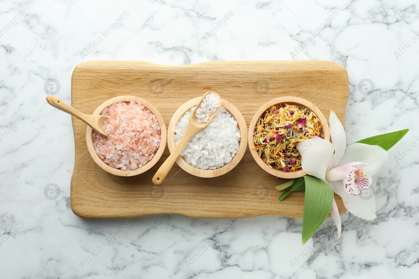 Photo of Flat lay composition with different spa products and orchid on white marble table