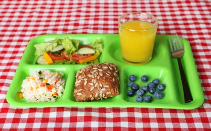 Serving tray with healthy food on table. School lunch