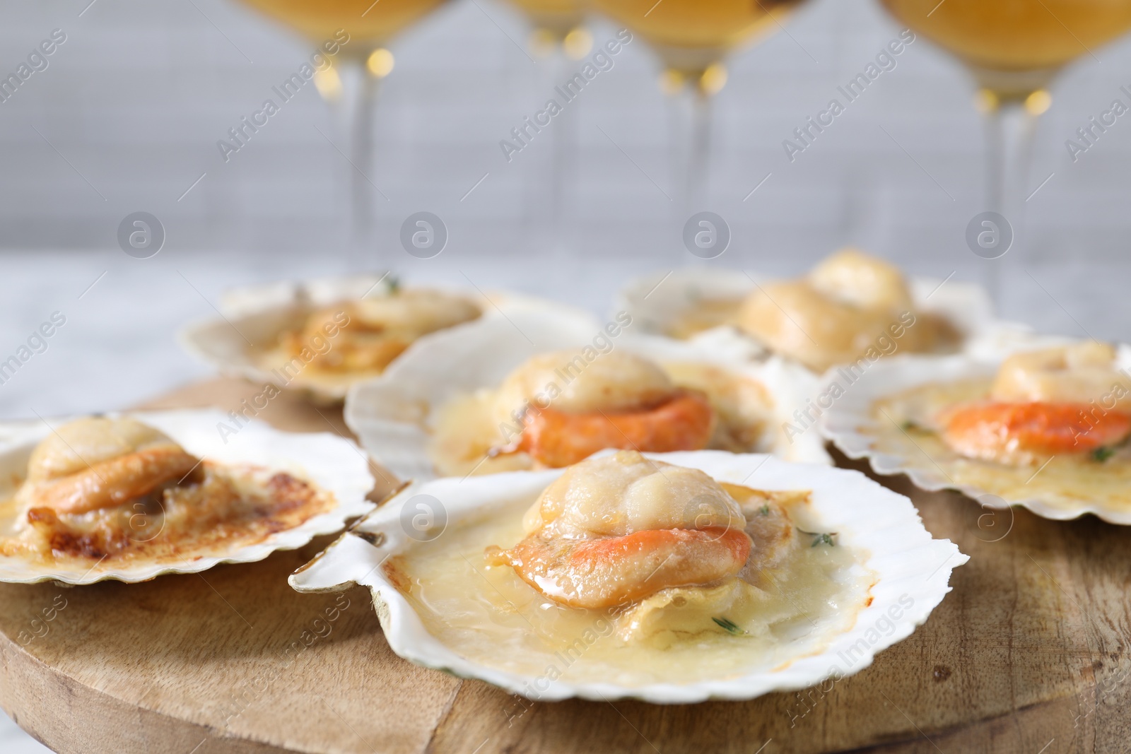 Photo of Fried scallops in shells on table, closeup