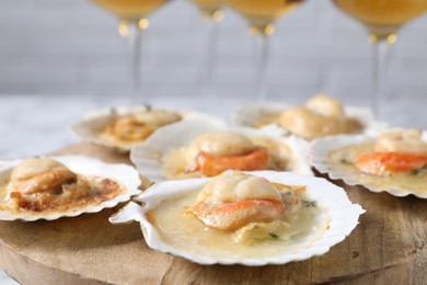 Fried scallops in shells on table, closeup