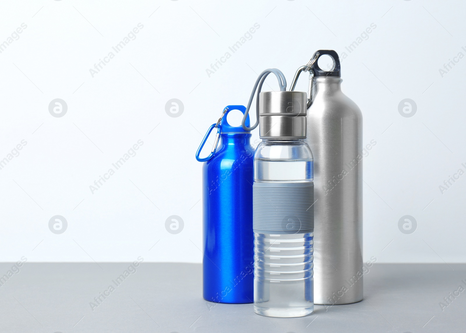 Photo of Different sport bottles with space for text on white background