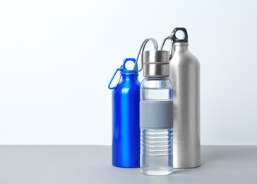 Photo of Different sport bottles with space for text on white background