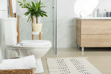 Photo of Stylish toilet bowl in modern bathroom interior