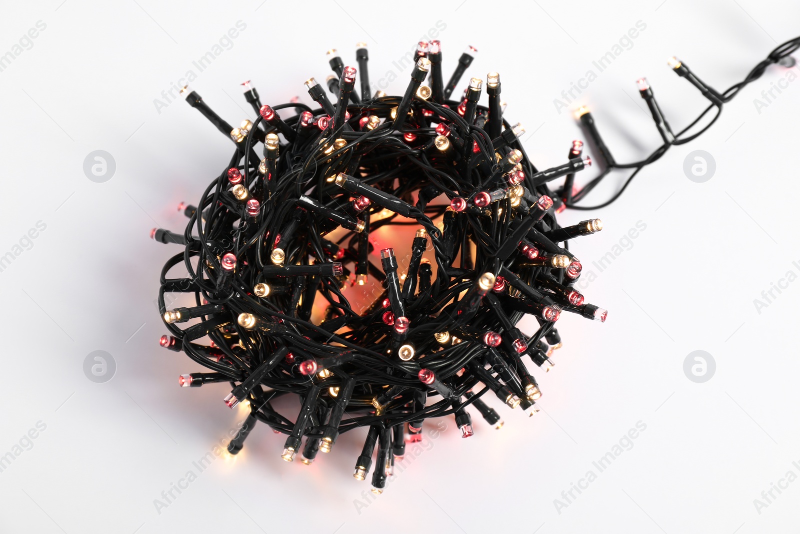 Photo of Bundle of beautiful Christmas lights on white background