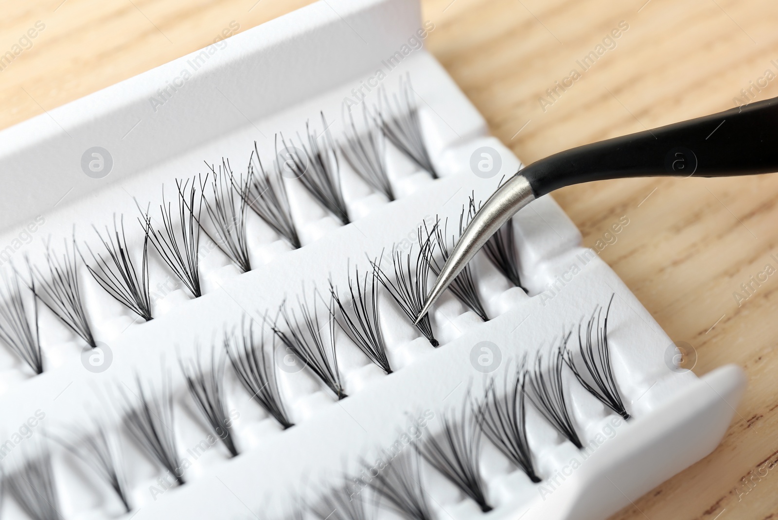 Photo of Tweezers with false eyelash, closeup