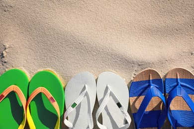 Stylish flip flops on beach, flat lay. Space for text