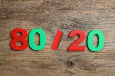 Photo of Colorful numbers 80 and 20 on wooden background, flat lay. Pareto principle concept