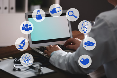 Medical student working with laptop indoors, closeup