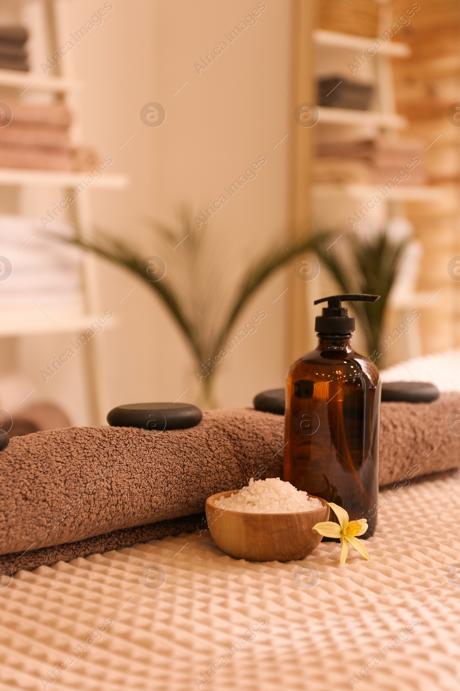 Photo of Beautiful spa accessories on massage table in room