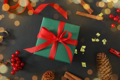 Photo of Flat lay composition with Christmas gift box and decor on black background
