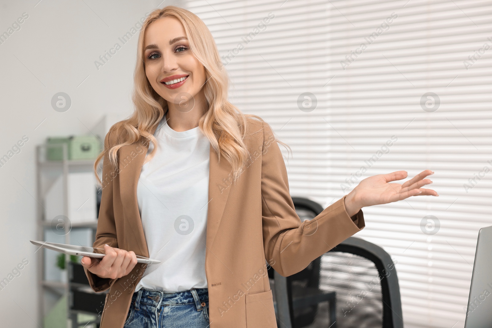 Photo of Portrait of happy secretary with tablet in office