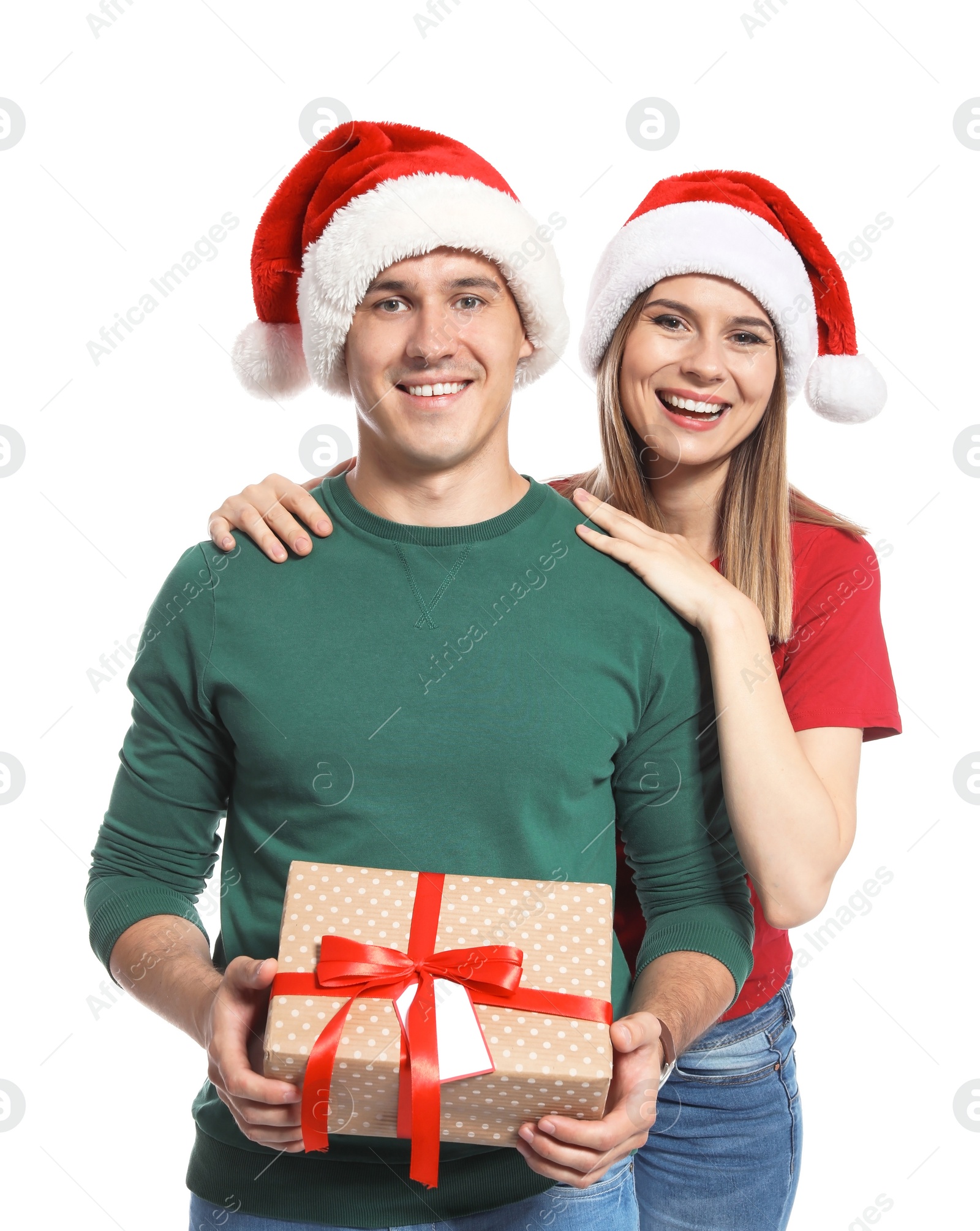 Photo of Young couple with Christmas gift on white background