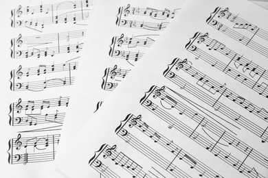 Music sheets. Melodies written with different musical symbols as background, closeup